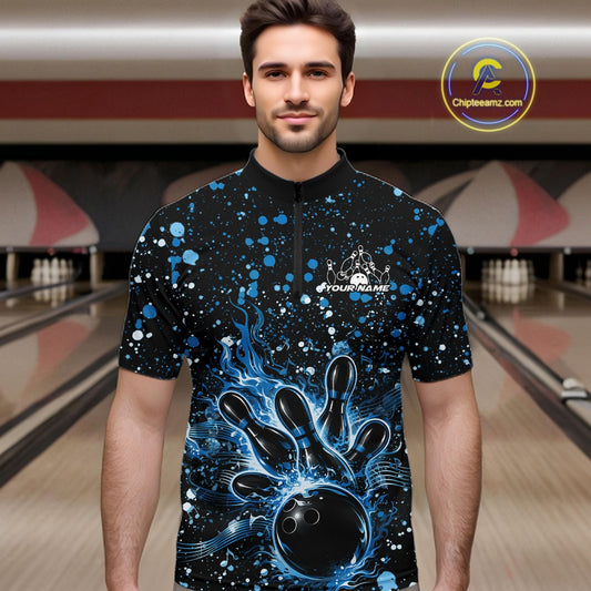 Male model wearing a black bowling quarter-zip shirt at the lane with blue music-inspired paint splatters and bowling artwork.