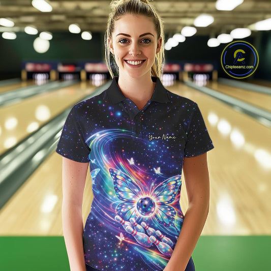 Female model in a bowling venue wearing a colorful bowling polo shirt featuring glowing butterfly wings and a bowling ball motif.