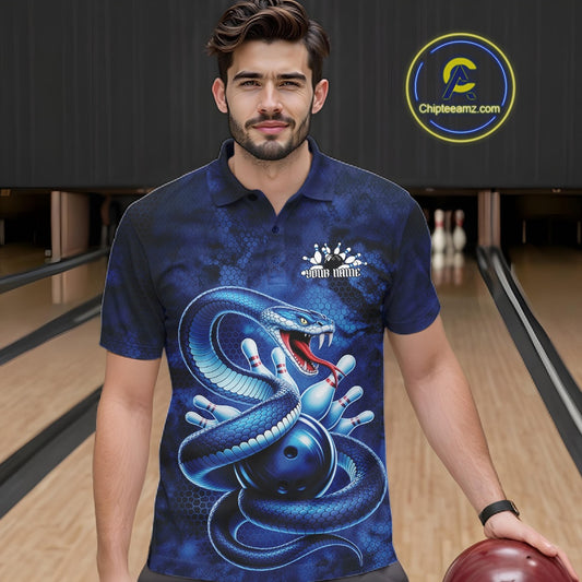 Male model wearing a bowling polo in a bowling lane with blue cobra graphics wrapped around a bowling ball.