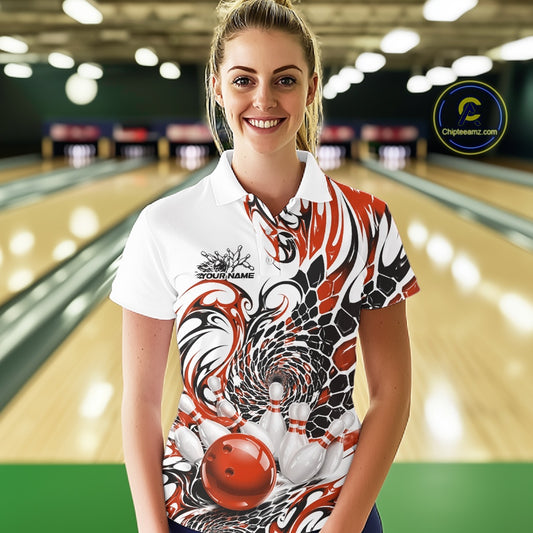 Female model in a bowling alley wearing a white bowling polo shirt with orange and black tribal artwork and bowling-themed graphics