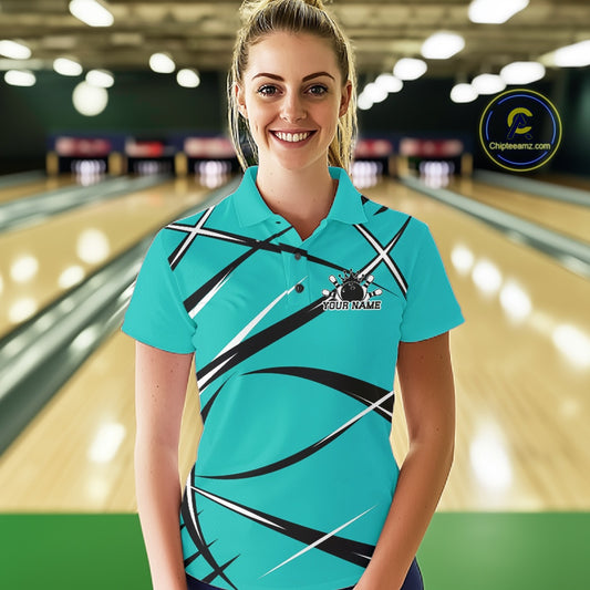 Front view of a female bowler in a bowling alley wearing a turquoise blue, black, and white bowling polo shirt with a sporty jersey design