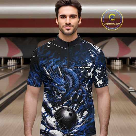 Man wearing a blue dragon-themed bowling shirt in a bowling alley.