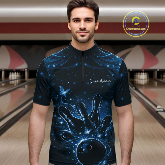 Male model wearing a black and blue bowling quarter-zip shirt at the lane with luminous butterfly bowling artwork.