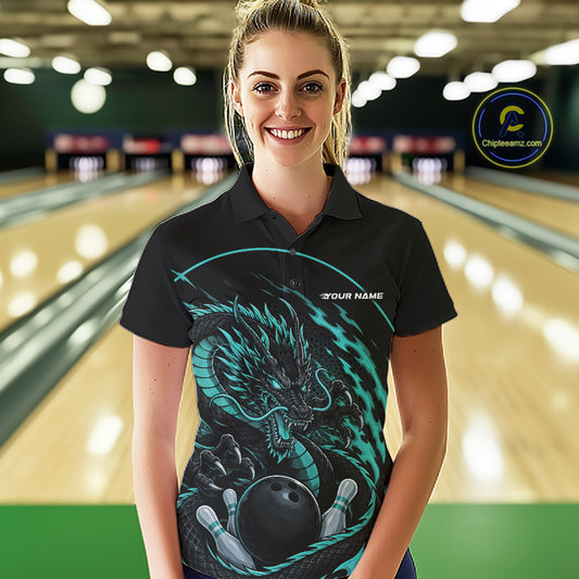Front view of a female model in a bowling alley wearing a blue custom bowling polo shirt featuring an aggressive dragon with flames in a dynamic and energetic design.