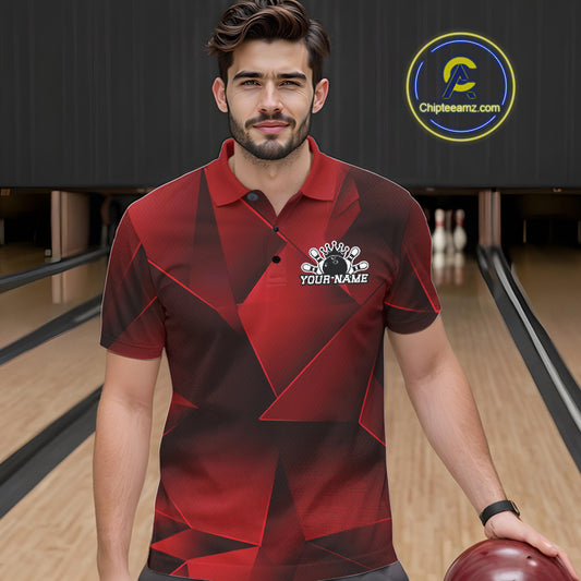 Man wearing a red and black bowling shirt with a logo in a bowling alley.