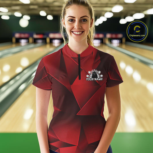 Woman wearing a red and black bowling shirt with a personalized design in a bowling alley.