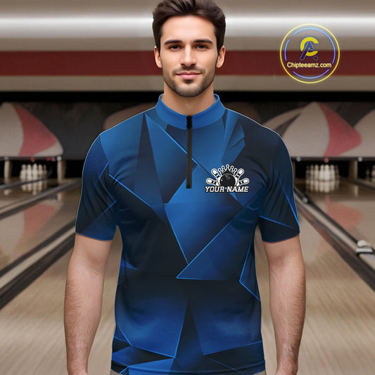 Man wearing a blue bowling shirt with a logo in a bowling alley
