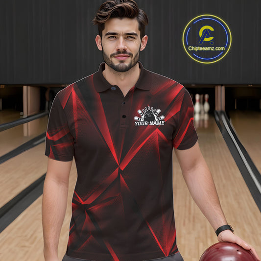 Man wearing a red and black bowling shirt with a logo in a bowling alley.