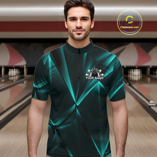 Man wearing a green bowling shirt with a logo and text in a bowling alley.