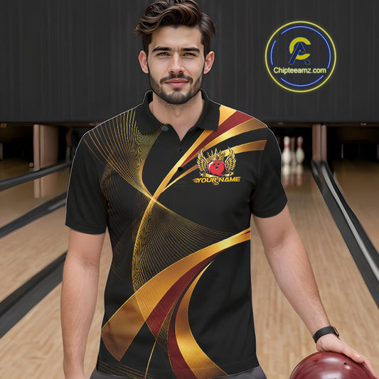 Man wearing a black bowling shirt with gold and red design in a bowling alley.