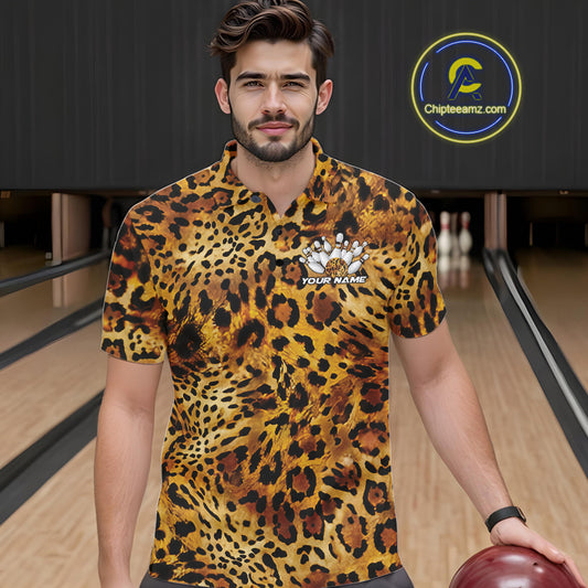 A man stands in a bowling alley wearing a yellow, brown, and black leopard-print bowling shirt with a bowling pin graphic and “Your Name” on the chest.