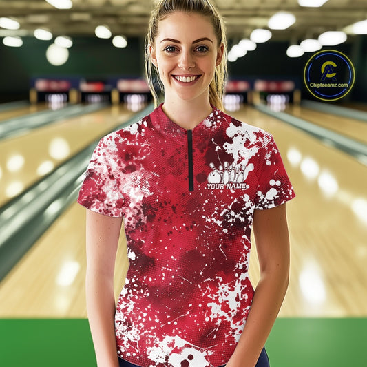 Woman wearing a pink and white bowling shirt with a personalized name on a bowling alley.
