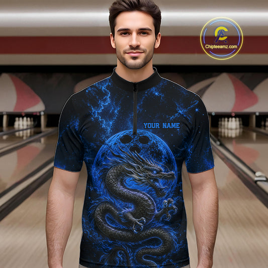 Front view of a male model in a bowling alley wearing a blue custom quarter-zip bowling shirt featuring an ancient dragon, flames, and a moon-inspired bowling ball design.