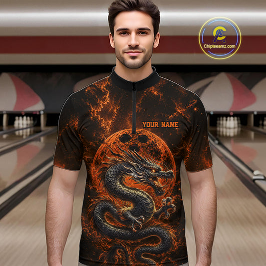 Front view of a male model in a bowling alley wearing an orange custom quarter-zip bowling shirt featuring an ancient dragon, flames, and a moon-inspired bowling ball design.