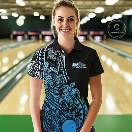 Female model wearing a black and blue bowling polo shirt at the bowling lane with tribal swirl bowling graphics.