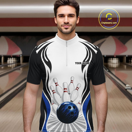 Male model wearing a white, black, and blue bowling quarter zip shirt with bowling ball knocking down pins artwork, shown from the front in a bowling lane.