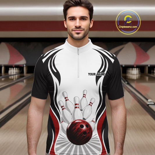 Front view of a male model at the bowling lane wearing a white, black, and red bowling quarter-zip shirt with bowling ball and pins graphics.