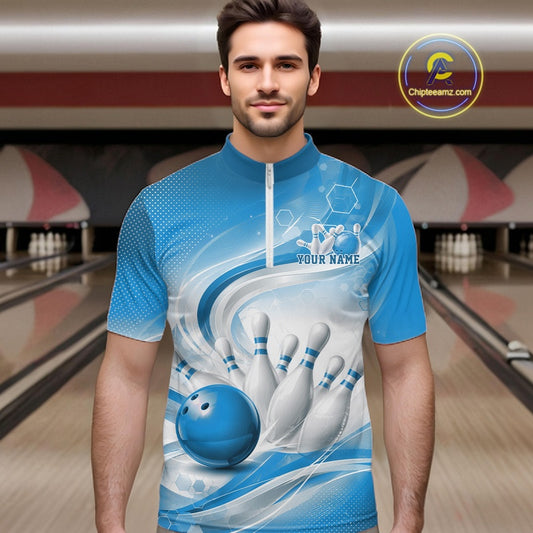 Male model standing in a bowling lane wearing a white and blue bowling quarter-zip shirt featuring abstract wave lines and a glossy bowling ball striking pins on the front.