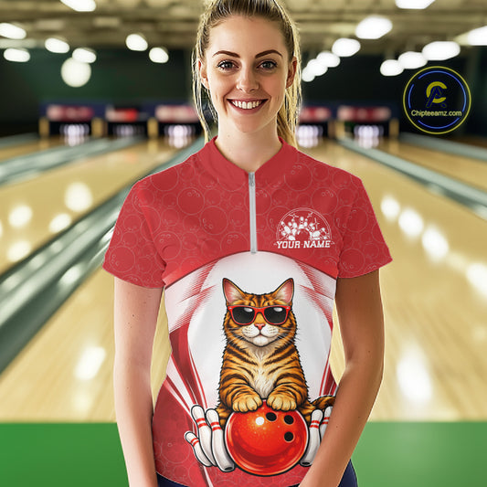 Female model wearing a bowling quarter-zip shirt at the bowling lane with a golden brown Bengal cat, sunglasses, and bowling ball illustration.
