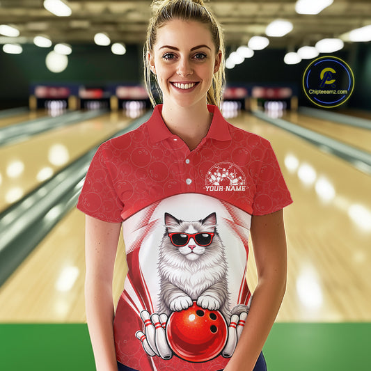 Female model at a bowling lane wearing a bowling polo shirt with a ragdoll cat in sunglasses and bowling ball artwork.