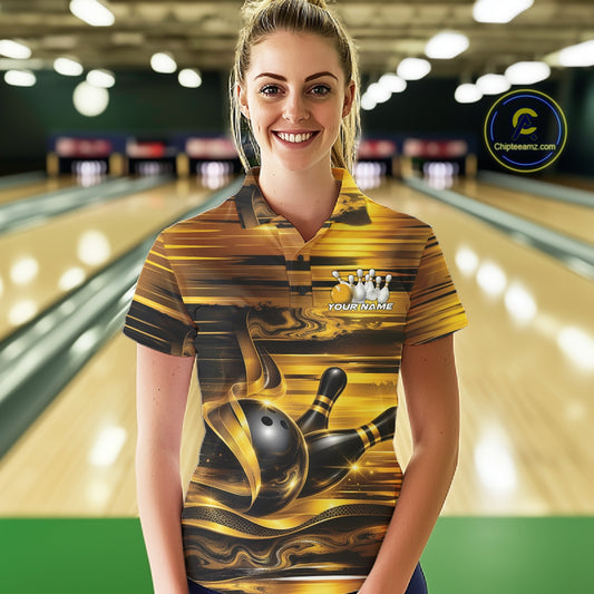 Front view of a female model wearing a bowling polo shirt featuring glossy gold and black bowling ball and pins artwork at a bowling lane.