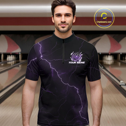 Male model wearing a black and purple quarter-zip in a bowling alley with dragon claw artwork and fiery bowling graphics.