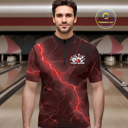 Male model at the bowling lane wearing a quarter-zip with red cobra artwork, bowling ball details, and lightning-inspired accents.