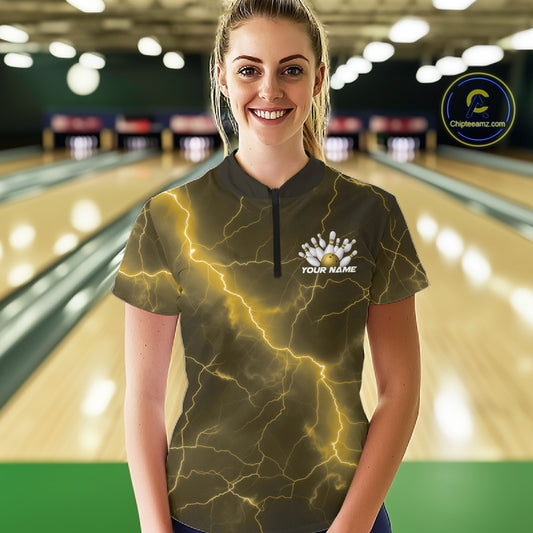 Female model in a bowling lane wearing a quarter-zip with yellow cobra bowling artwork and lightning fantasy details.