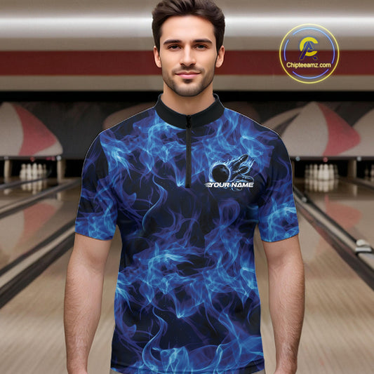 Male model wearing a blue quarter-zip at the bowling lane with fiery bowling ball artwork.