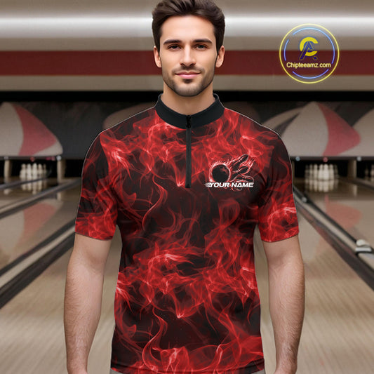 Male model at a bowling alley wearing a red quarter-zip with blazing bowling ball artwork.