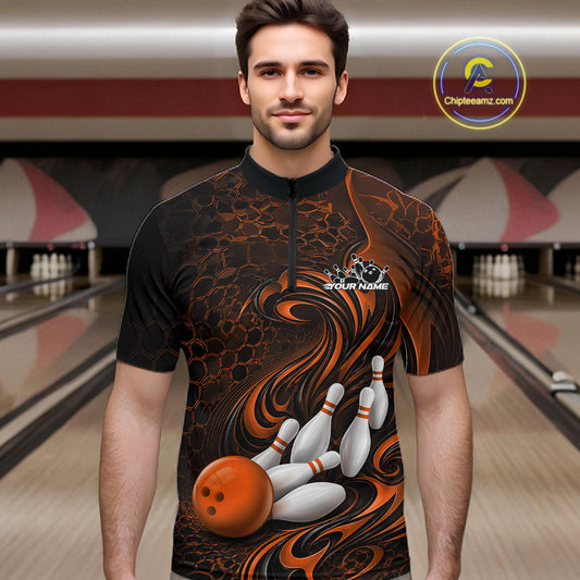 Male model standing in a bowling lane wearing a black and orange bowling quarter-zip shirt featuring a tribal flame bowling ball and pins graphic on the front.