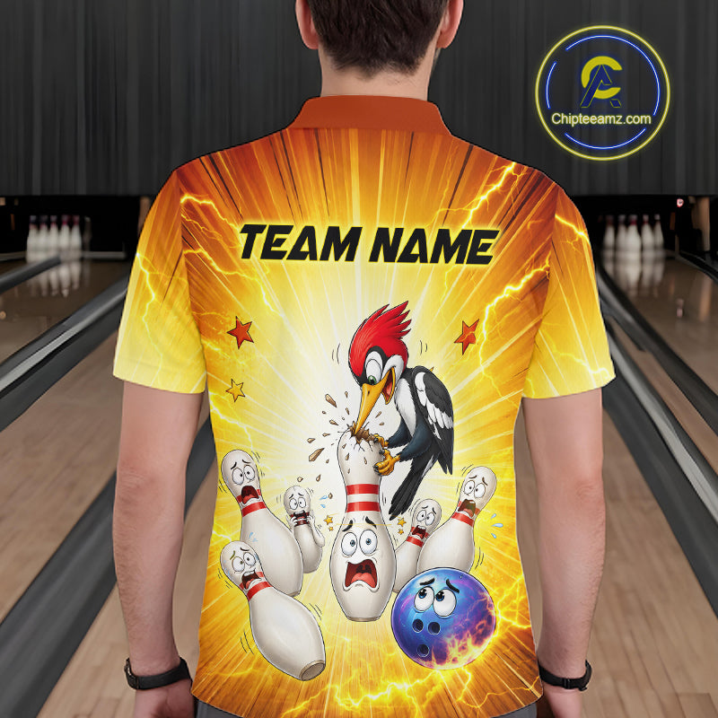 Person wearing a bowling-themed shirt with cartoon woodpecker and bowling pins in a bowling alley.