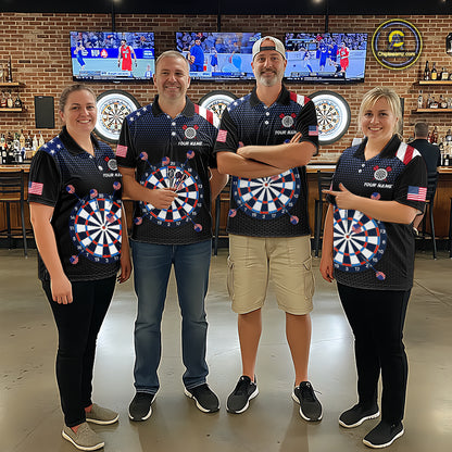 Group of four wearing matching custom patriotic dart polo shirts featuring American flag dartboard graphics in a professional dart room.
