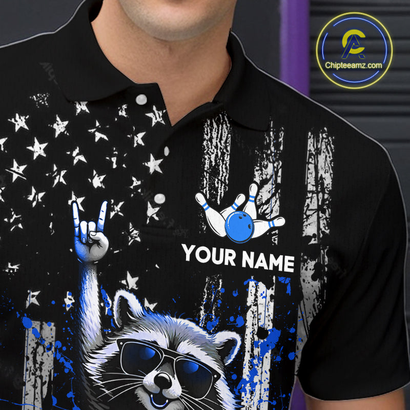 Black polo shirt with a raccoon wearing sunglasses, rock hand gesture, and blue bowling ball design. 'Your Name' text space.