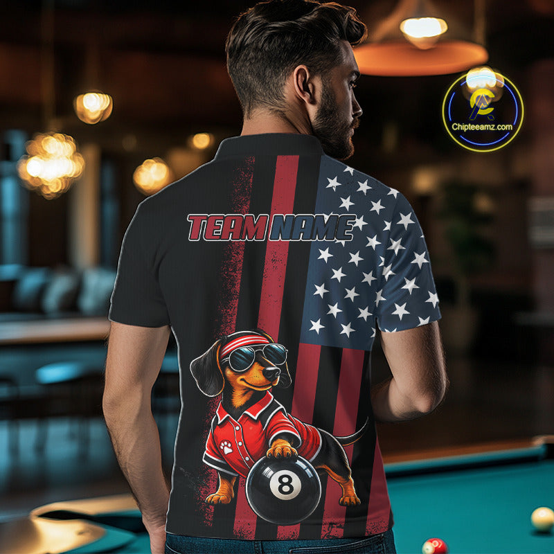 A man viewed from behind wearing a custom-printed short-sleeve polo shirt in a pool hall. The back of the shirt features a split design: one side is black with a vertical red stripe and 'TEAM NAME' text, while the other side has an American flag pattern with white stars.