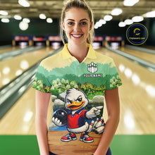 Load image into Gallery viewer, Woman wearing a bowling-themed shirt with a cartoon duck character in a bowling alley.