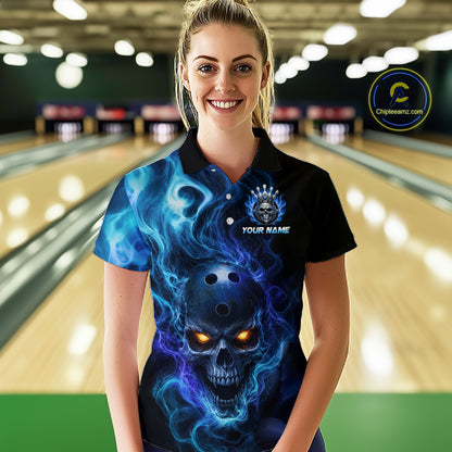 Woman wearing a black bowling polo shirt featuring a flaming skull with glowing orange eyes, blue smoke effects, and custom “YOUR NAME” text.