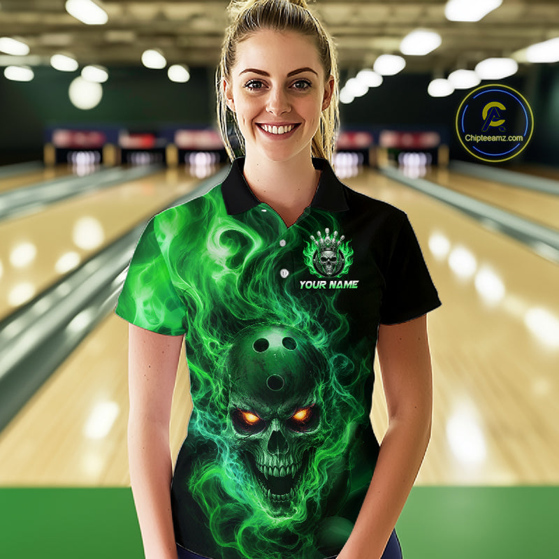 Woman wearing a black bowling polo shirt featuring a flaming skull with glowing orange eyes, green smoke effects, and custom “YOUR NAME” text.
