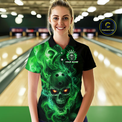 Woman wearing a black bowling polo shirt featuring a flaming skull with glowing orange eyes, green smoke effects, and custom “YOUR NAME” text.