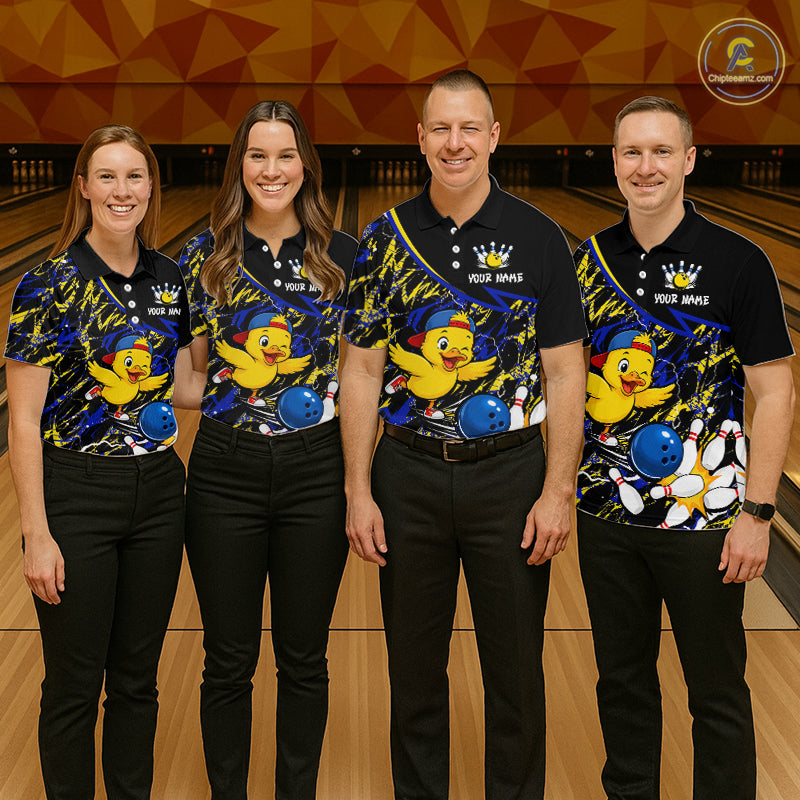 Four people wearing matching bowling shirts with a duck and ball design on a bowling alley.