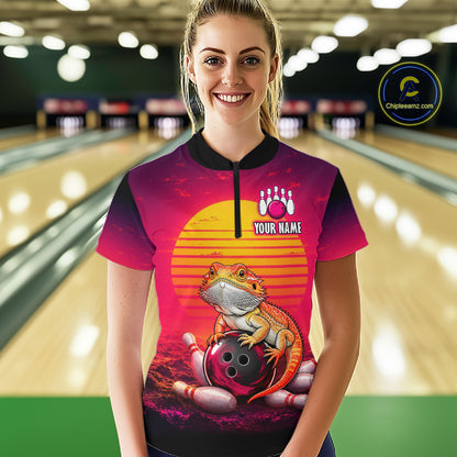 Women’s retro sunset bearded dragon bowling quarter zip shirt, front view on female model in bowling lane 
