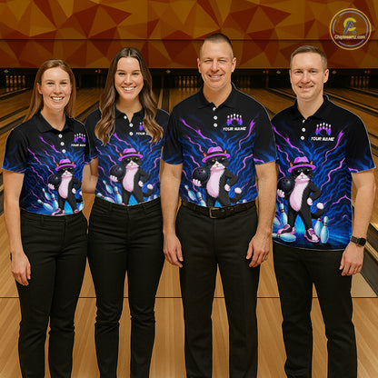 Four people standing in a bowling alley wearing matching black polo shirts with a colorful cartoon cat graphic in purple, pink, and blue, paired with black pants.