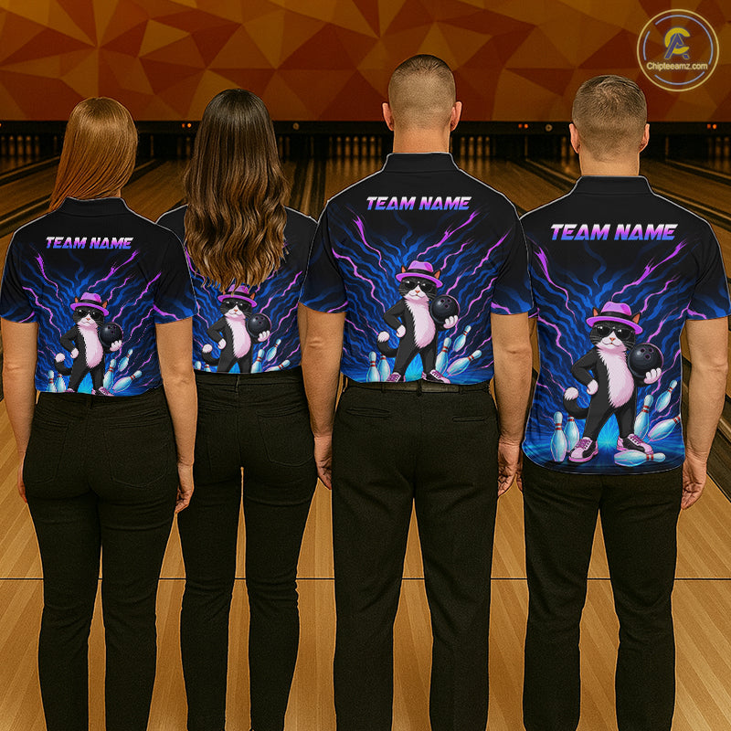 Four people standing with their backs to the camera in a bowling alley, wearing matching dark navy short-sleeve bowling shirts with a colorful graphic of a penguin in a pink bowler hat and purple lightning effects. The shirts also feature 'TEAM NAME' text across the upper back.