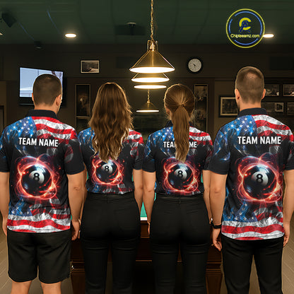 Four people standing with their backs to the camera in a dimly lit indoor room, wearing matching dark short-sleeve shirts with a patriotic American flag design and a large 8-ball pool graphic on the back. The shirts also have 'TEAM NAME' printed across the upper back.