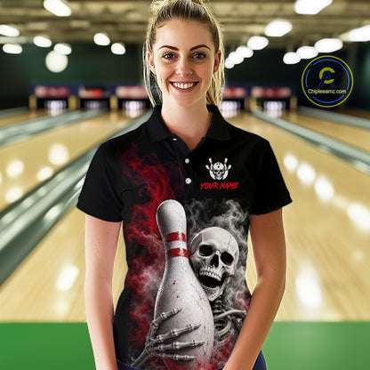 A woman wearing a black custom polo shirt with a graphic of a skeleton holding a bowling pin, set against a blurred bowling alley background. The shirt features a skull and crossbones logo on the left chest and the text 'YOUR NAME' in red.