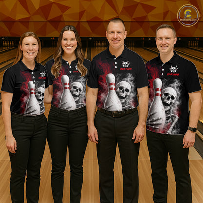 Four people standing together in a bowling alley wearing matching black short-sleeve polo shirts with a large graphic print of a skull and bowling pins, paired with black pants. A circular logo for Bowling.