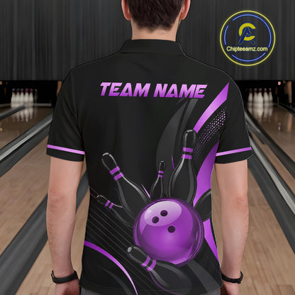 Person wearing a black bowling shirt with purple graphics and text in a bowling alley.