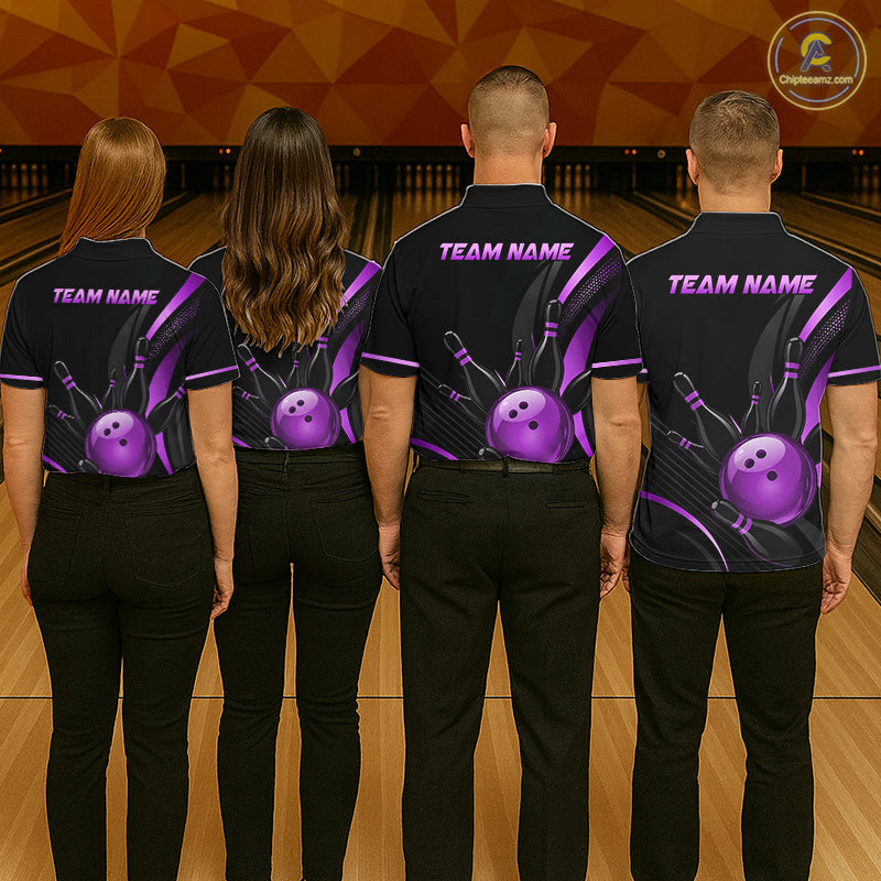 Four people wearing black bowling shirts with a purple bowling ball design on a bowling alley.