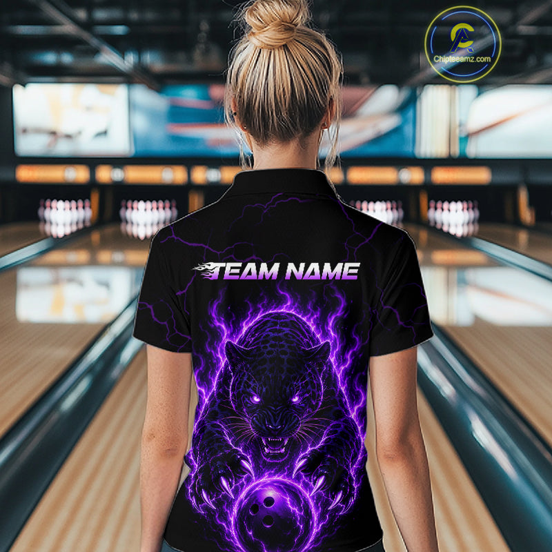 Person wearing a black shirt with a purple panther design and 'TEAM NAME' text in a bowling alley.