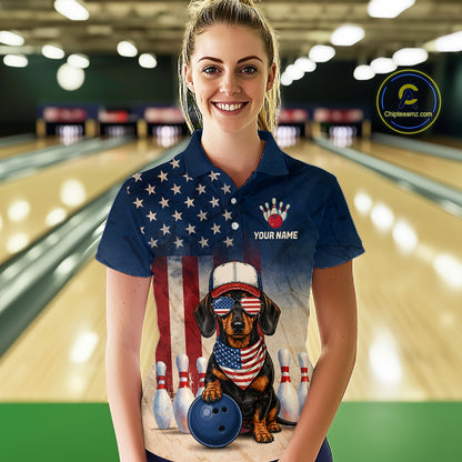 Woman wearing a bowling-themed shirt with a dog design in a bowling alley.